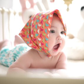 A Baby Wearing Scarf