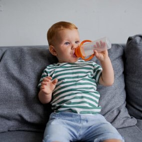 A baby sipping drink